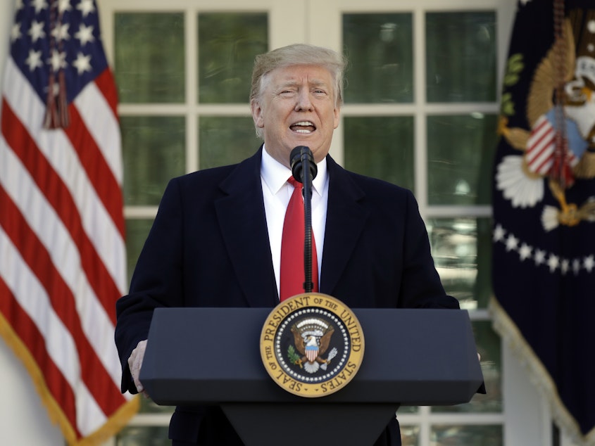 caption: President Trump speaks in the Rose Garden of the White House on Friday, saying he will endorse a short-term spending deal to end the government shutdown.
