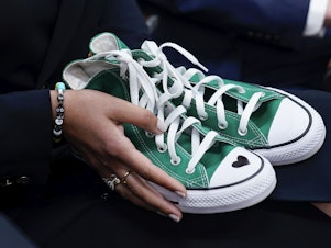 caption: Camila Alves McConaughey holds green Converse sneakers. Uvalde, Texas, school shooting victim Maite Rodriguez, who died at age 10, was wearing green Converse shoes when she died.