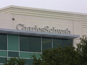 caption: Charles Schwab is slashing its online trading commission from $4.95 to zero starting Monday. The company cited competition from new online rivals.