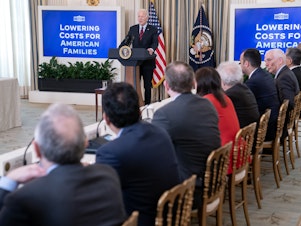caption: President Biden convened his Competition Council at the White House on March 5 after his administration announced new actions to cap credit card late fees at $8, compared with $32.