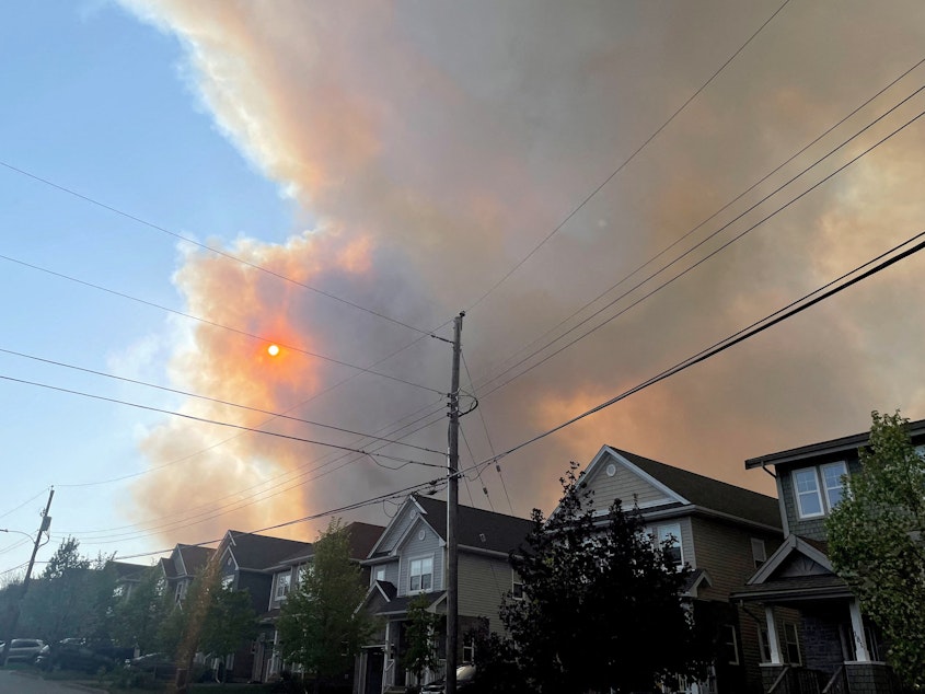 caption: Smoke from the Tantallon wildfire rises over houses in nearby Bedford, Nova Scotia, Canada, on Sunday.