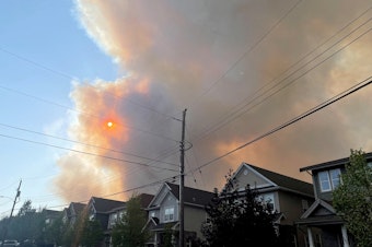 caption: Smoke from the Tantallon wildfire rises over houses in nearby Bedford, Nova Scotia, Canada, on Sunday.