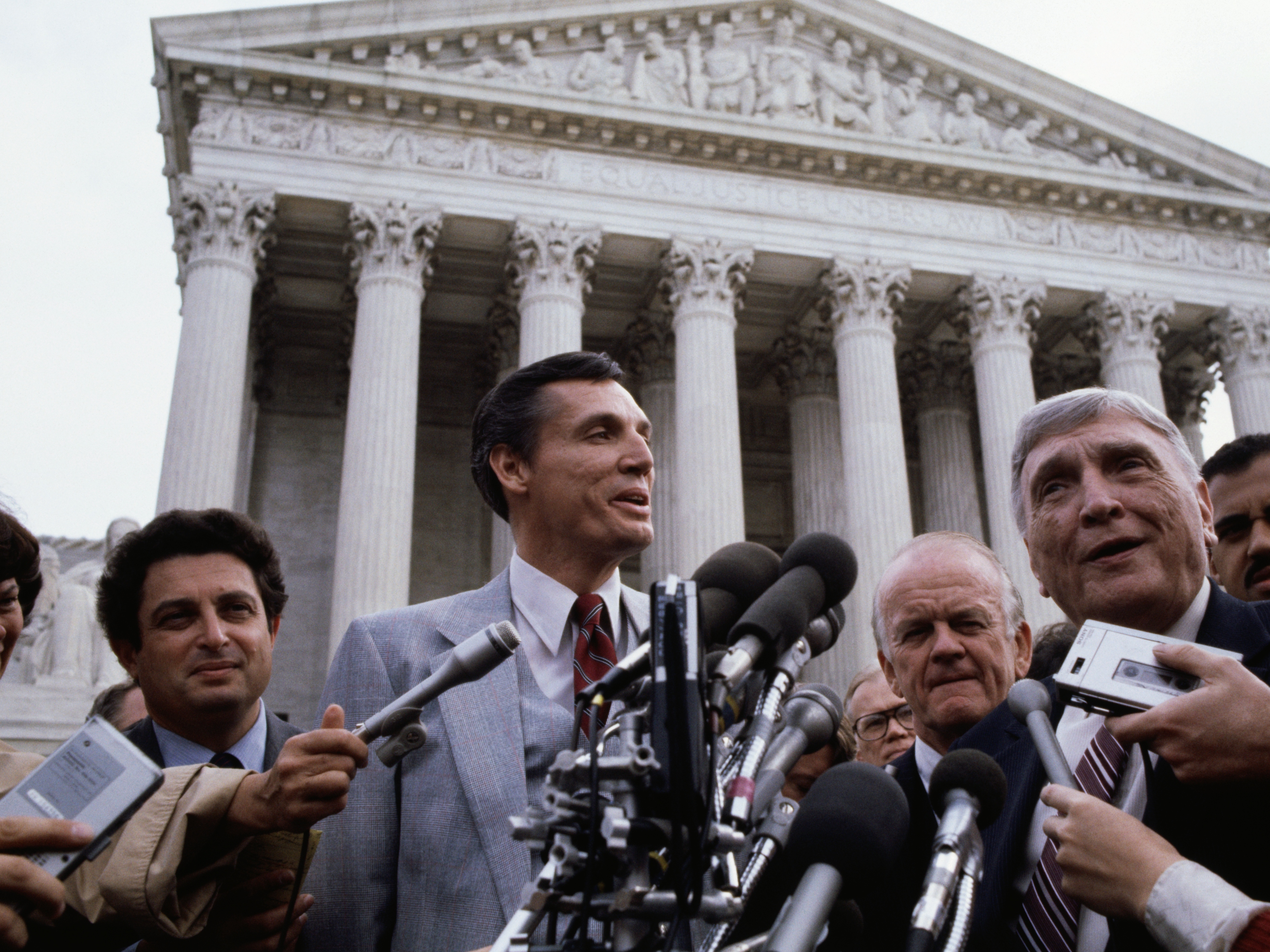 caption: Bob Jones III, the president of Bob Jones University, speaks outside the U.S. Supreme Court in 1982. The IRS rescinded the university's tax-exempt status in the 1976.