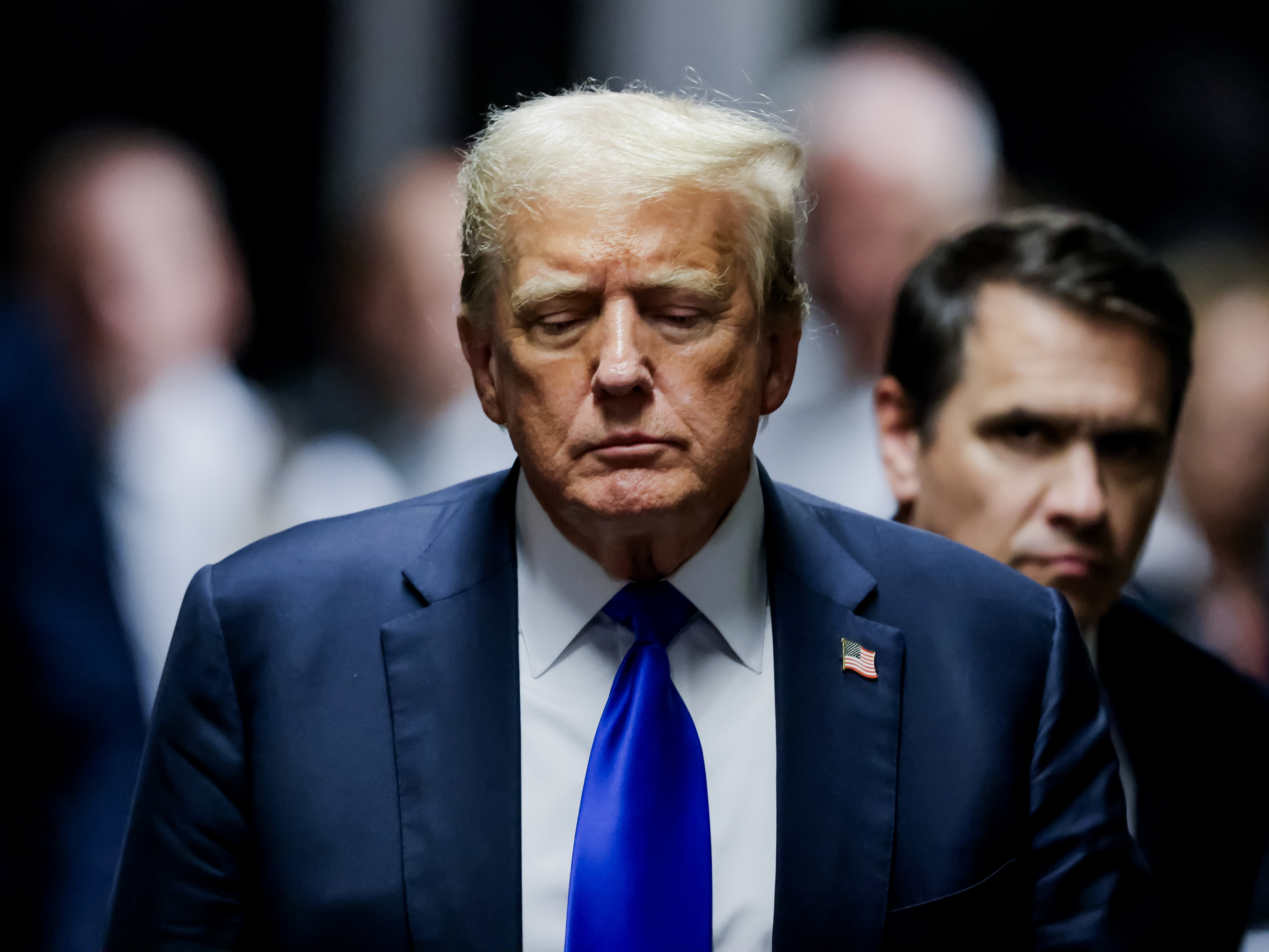 caption: Former President Donald Trump departs the courtroom after being found guilty on all 34 counts in his hush money trial at Manhattan Criminal Court on May 30 in New York City.