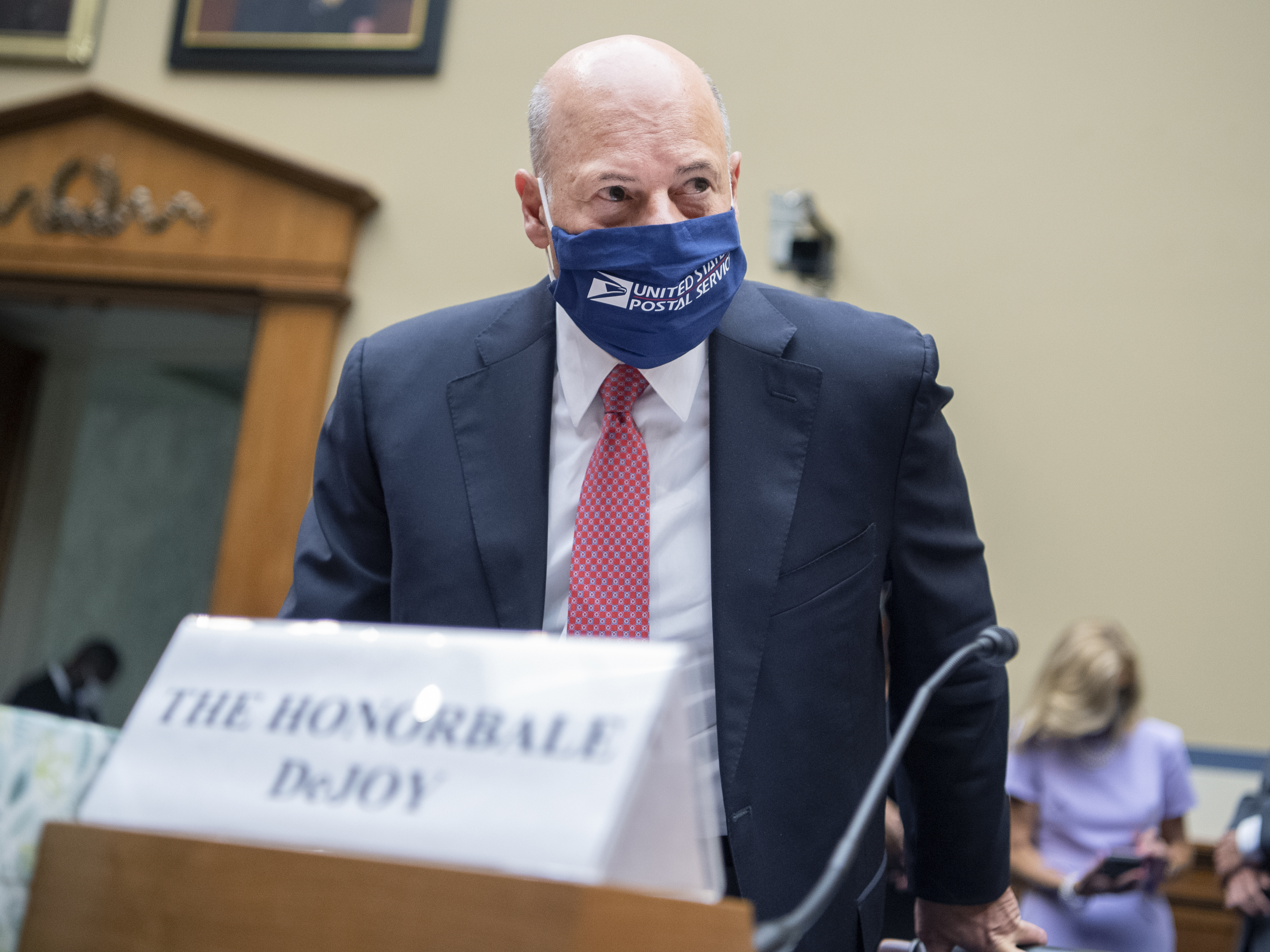 caption: Postmaster General Louis DeJoy, pictured on Aug.  24, 2020, is testifying Wednesday about poor mail delivery rates.