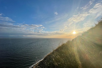 caption: The sun shines over Bluff Trail in Whidbey Island's Fort Ebey State Park on June 18, 2023.