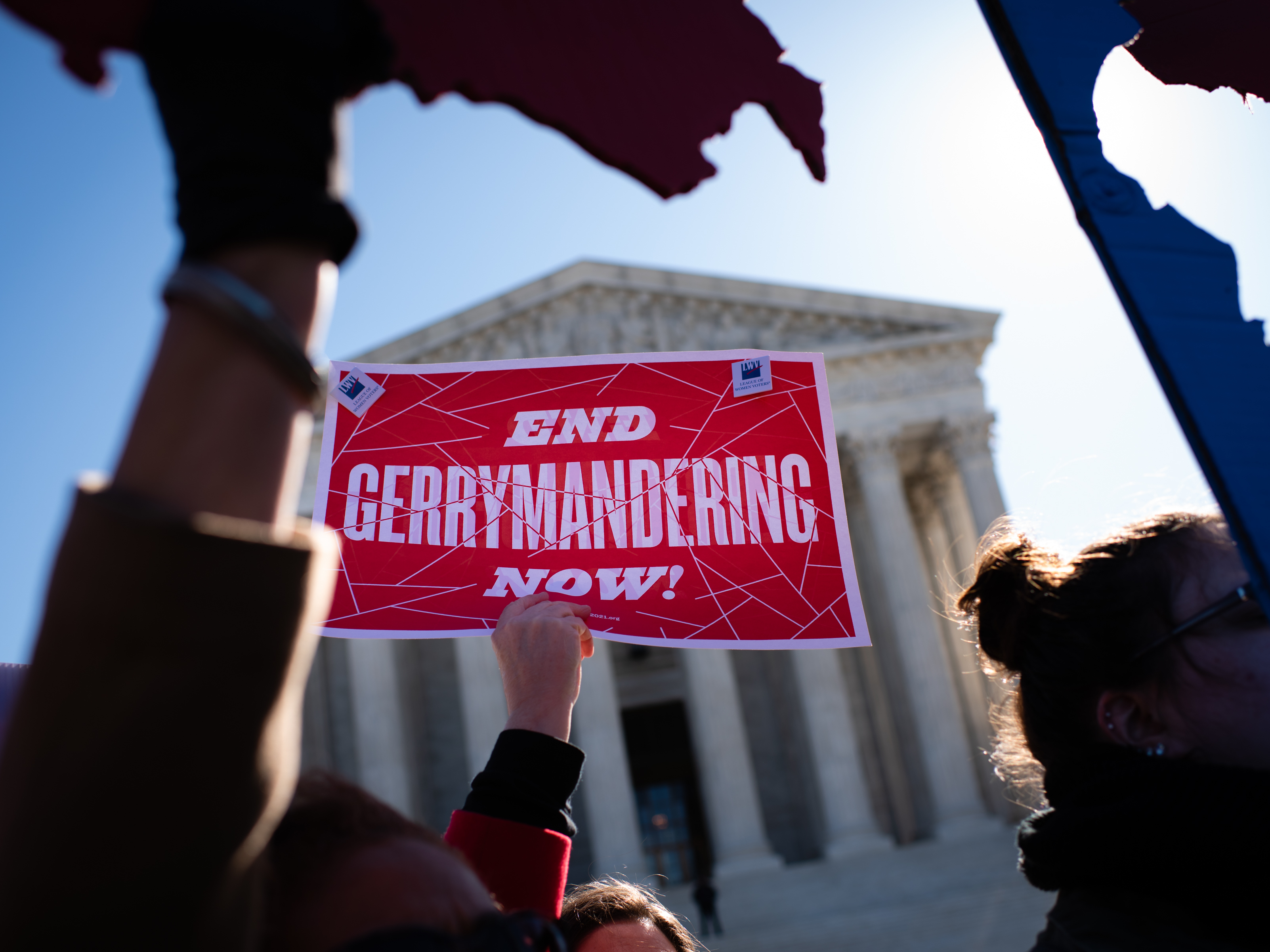caption: An activist holds a sign outside the U.S. Supreme Court in 2019.