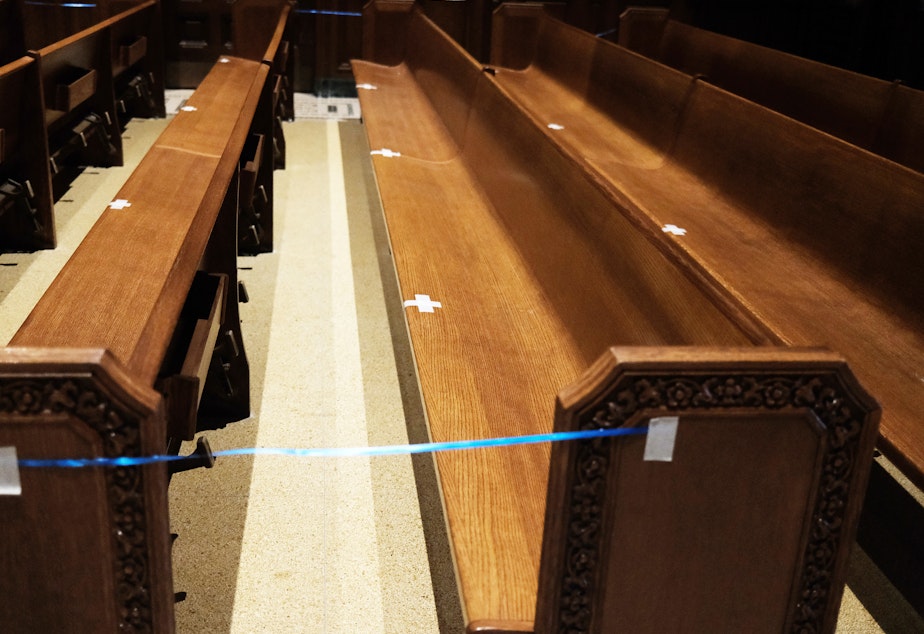 caption: Empty pews are marked for spacing in a Manhattan church on Nov. 27, 2020 in New York City.
