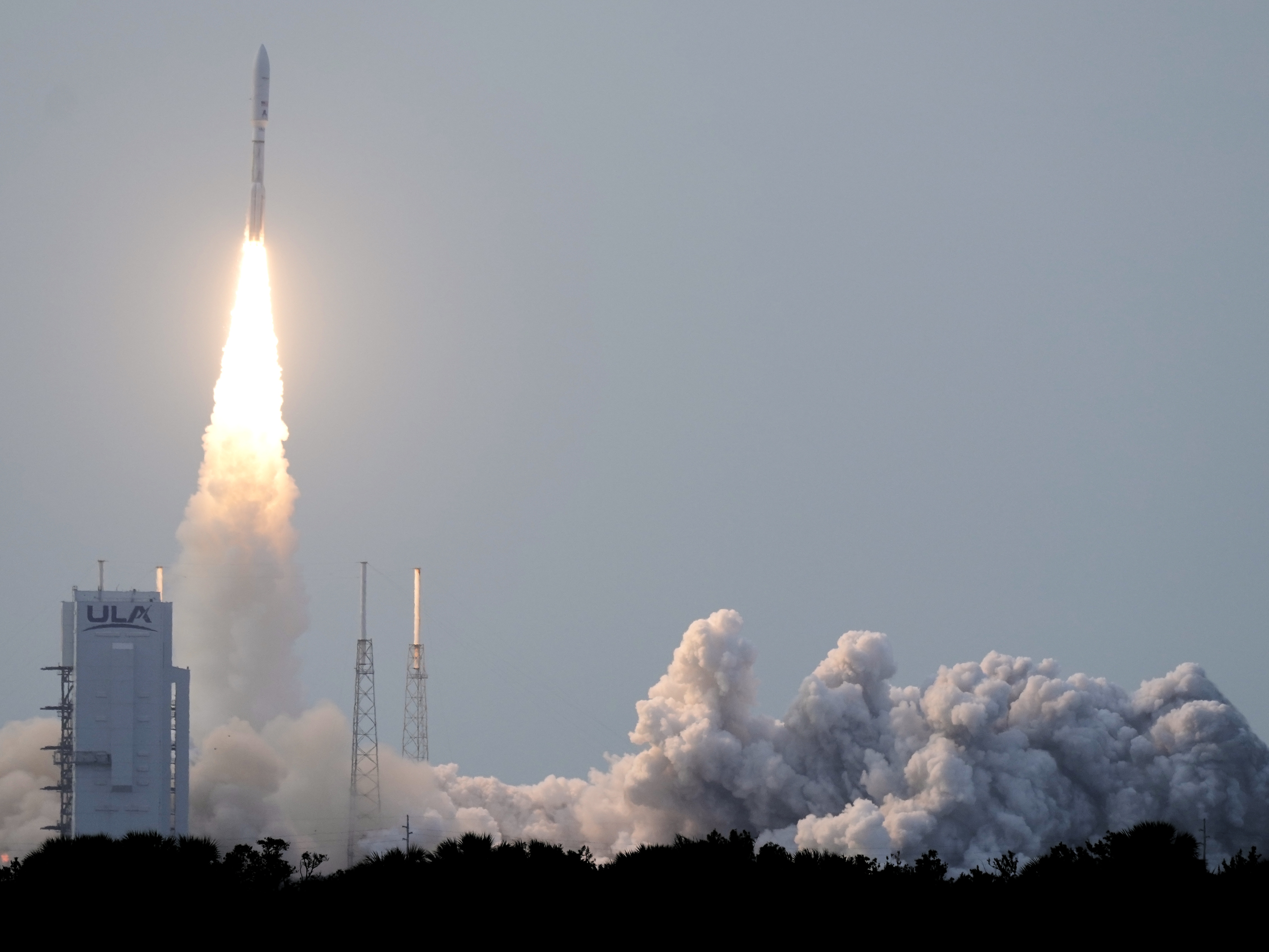 caption: A United Launch Alliance Atlas V rocket with a payload of 27 of Amazon's Project Kuiper internet satellites lifts off from Launch Complex 41 at the Cape Canaveral Space Force Station on Monday.