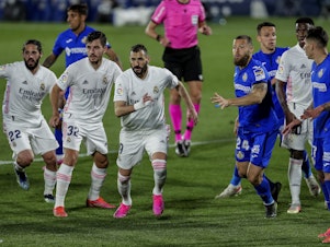 caption: Real Madrid players, left, duel with Getafe players during the Spanish La Liga soccer match at the Alfonso Perez stadium in Getafe, Spain, Sunday.