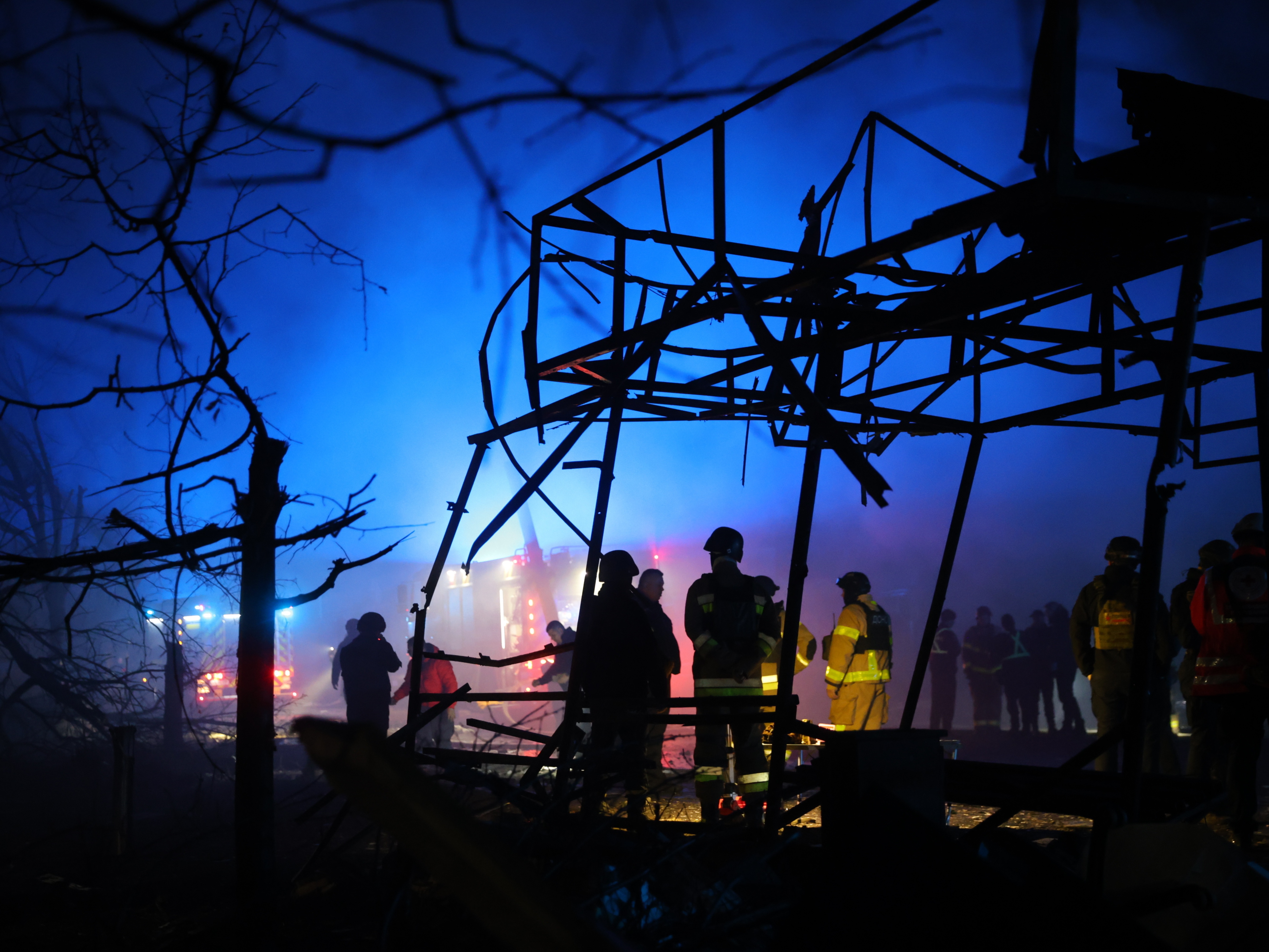 caption: Rescuers work at a market destroyed by a Russian airstrike on Zaporizhzhia, Ukraine, on Friday.