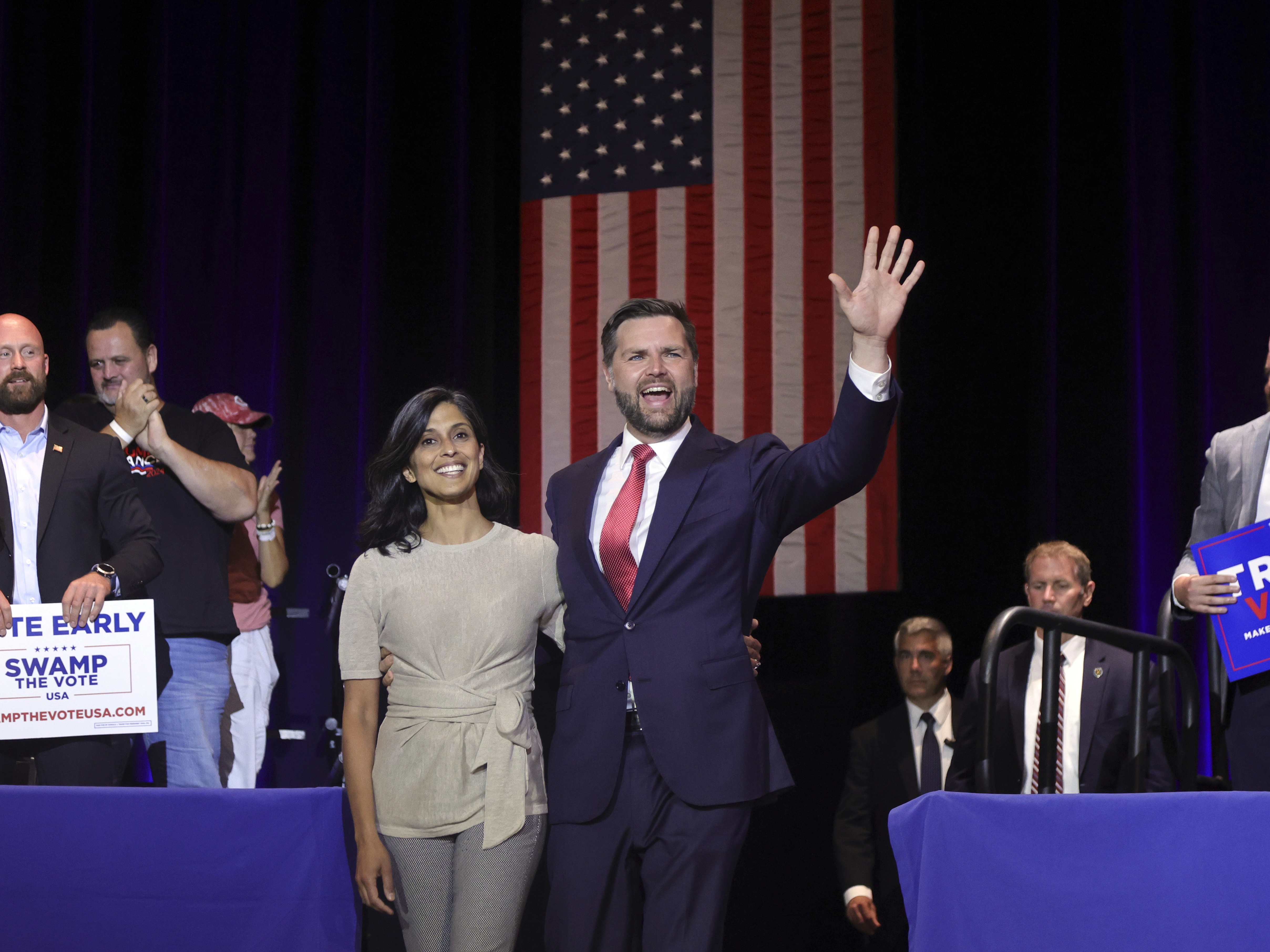 caption: Republican vice presidential candidate Sen. JD Vance, R-Ohio, right, takes the stage with his wife Usha Vance during a rally at Middletown High School in his home town of Middletown, Ohio, Monday.