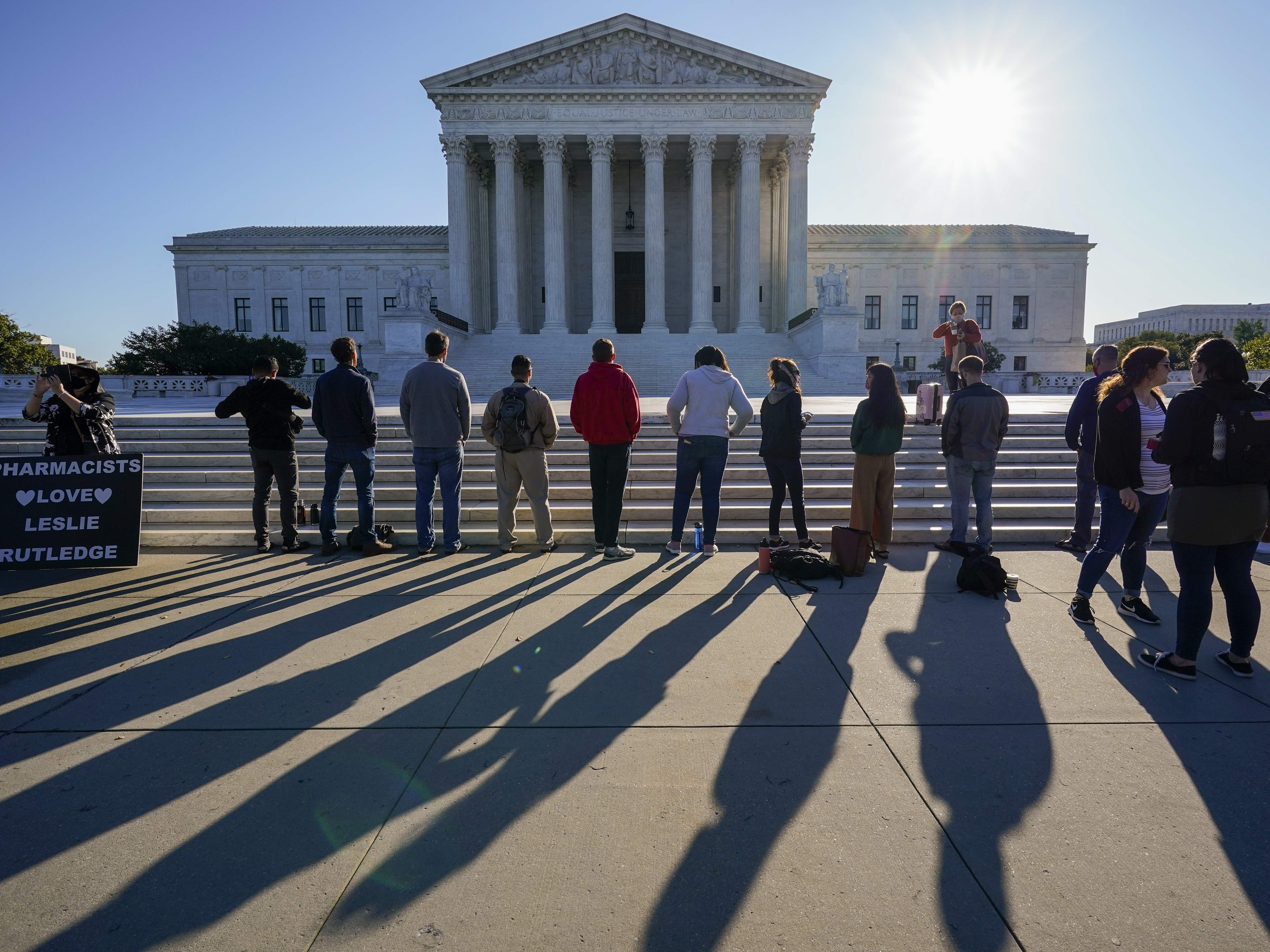 caption: Anti-abortion rights activists demonstrate at the Supreme Court in Washington on Oct. 5. The court's new conservative supermajority puts the fate of <em>Roe v. Wade</em> in doubt.