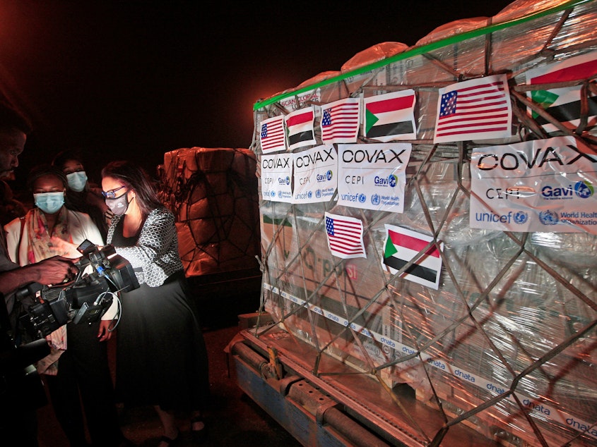 caption: COVID-19 vaccines from COVAX, the international vaccine-sharing program, arrive in Khartoum, Sudan, on Aug. 5. In a letter to President Biden, health experts are asking him to take action to manufacture and distribute vaccines to the entire world.