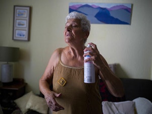 caption: Jackye Lafon, who's in her 80s, cools herself with a water spray at her home in Toulouse, France during a heat wave in 2022. Older people face higher heat risk than those who are younger. Climate change is making heat risk even greater.