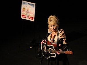caption: Dolly Parton performs at an event celebrating the Imagination Library at Tacoma's Pantages Theater, Aug. 15, 2023. The Rock & Roll Hall of Famer didn't perform her biggest hits, but instead shared songs with a personal connection to the program that provides free books for children.