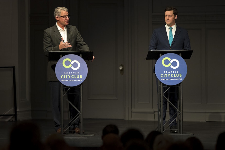 caption: Candidates for Seattle City Council in District 7, Jim Pugel, left, and Andrew Lewis debate at Town Hall Seattle. Lewis is getting more backing from labor, and Pugel is getting more backing from business. 