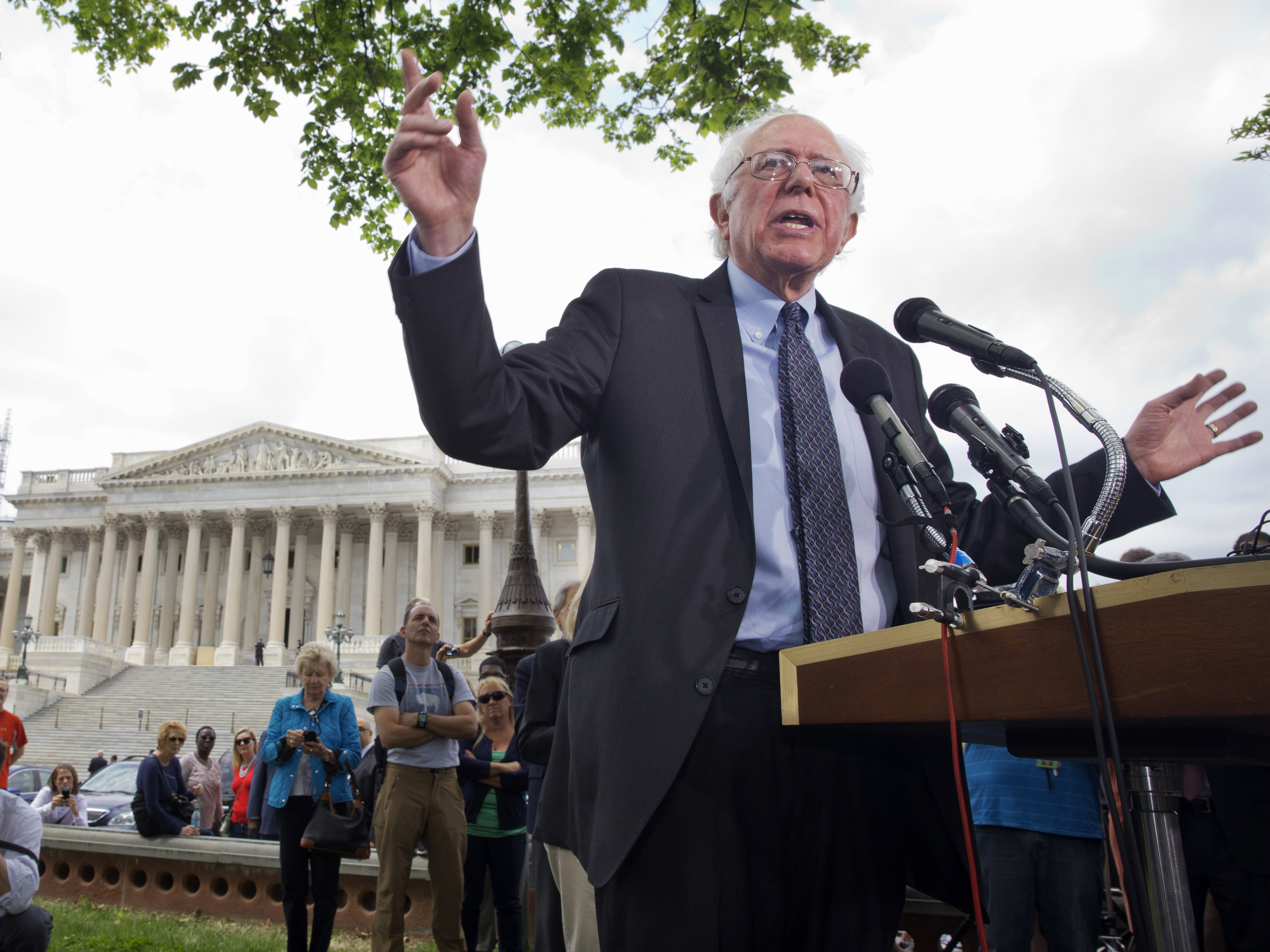 caption: Vermont independent Sen. Bernie Sanders announces his presidential bid on April 30, 2015, on Capitol Hill in front of media members and a small group of onlookers.