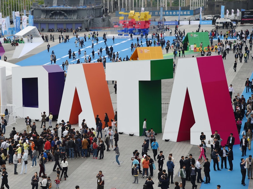 caption: Visitors walk past the giant word "Data" during the Guiyang International Big Data Expo 2016 in southwestern China. China says it's determined to be a leader in using artificial intelligence to sort through big data. U.S. officials say the Chinese efforts include the collection of hundreds of millions of records on U.S. citizens. The photo was released by China's Xinhua News Agency.