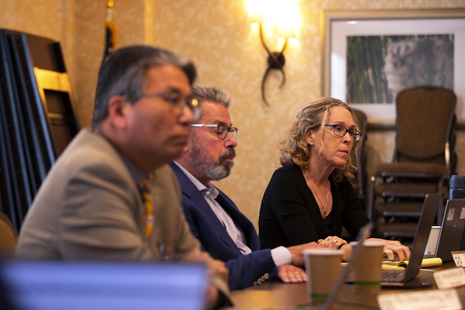 caption: Dr. Diana Currie, commission member, right, listens with other members during a Washington Medical Commission meeting on Thursday, June 13, 2024, at the Hilton Garden Inn in Olympia.