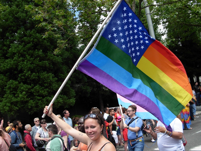caption: Marchers in the 2014 Pride Parade through downtown Seattle.