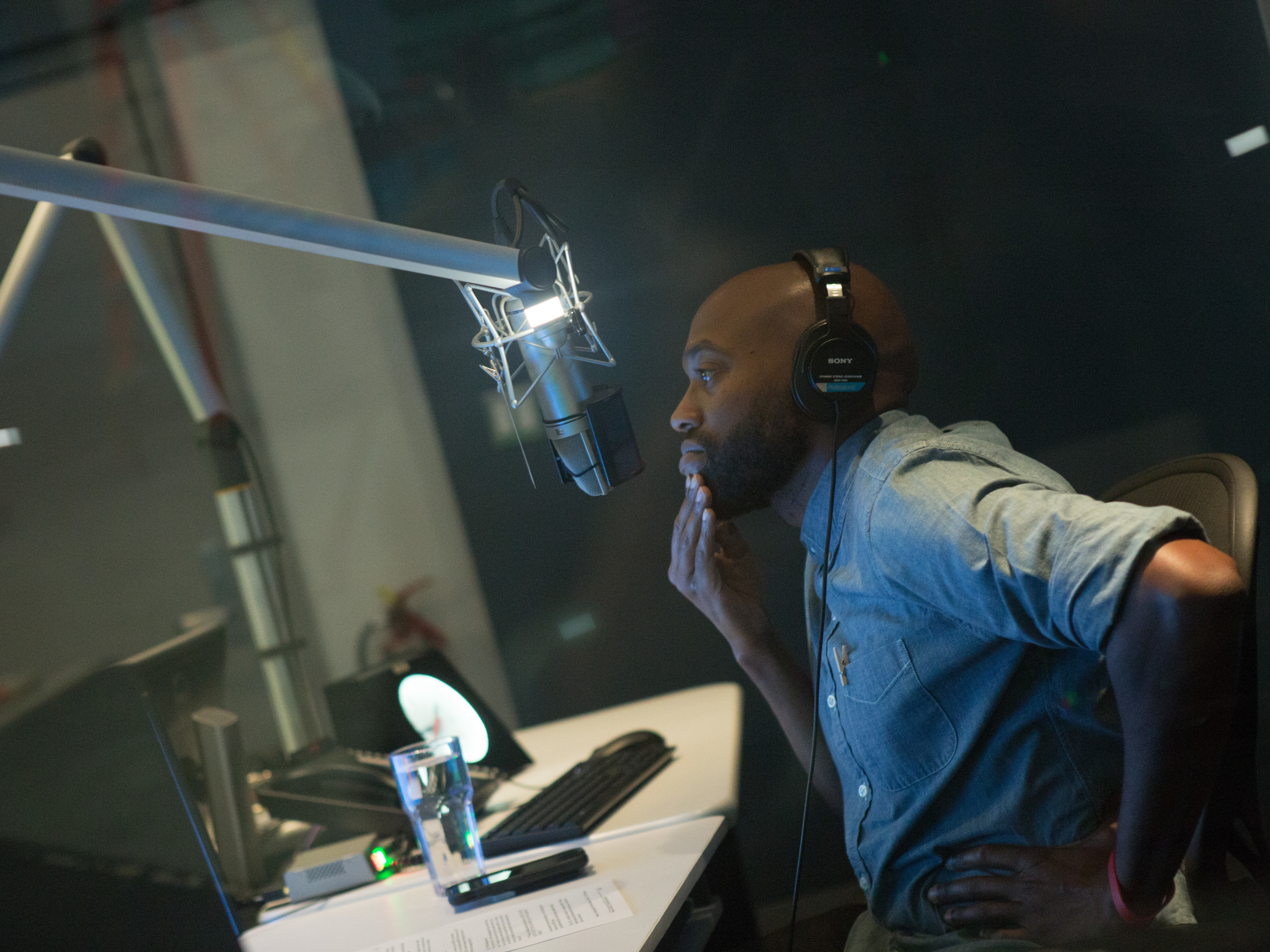 caption: Sam Sanders, host of NPR's <em>It's Been A Minute</em>, records a segment at NPR West on September 24, 2018.