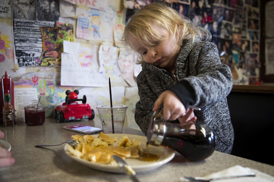 caption: Asher Dunn, 4, pours syrup onto his pancakes on Monday, March 11, 2019, at Beth's Cafe in Seattle