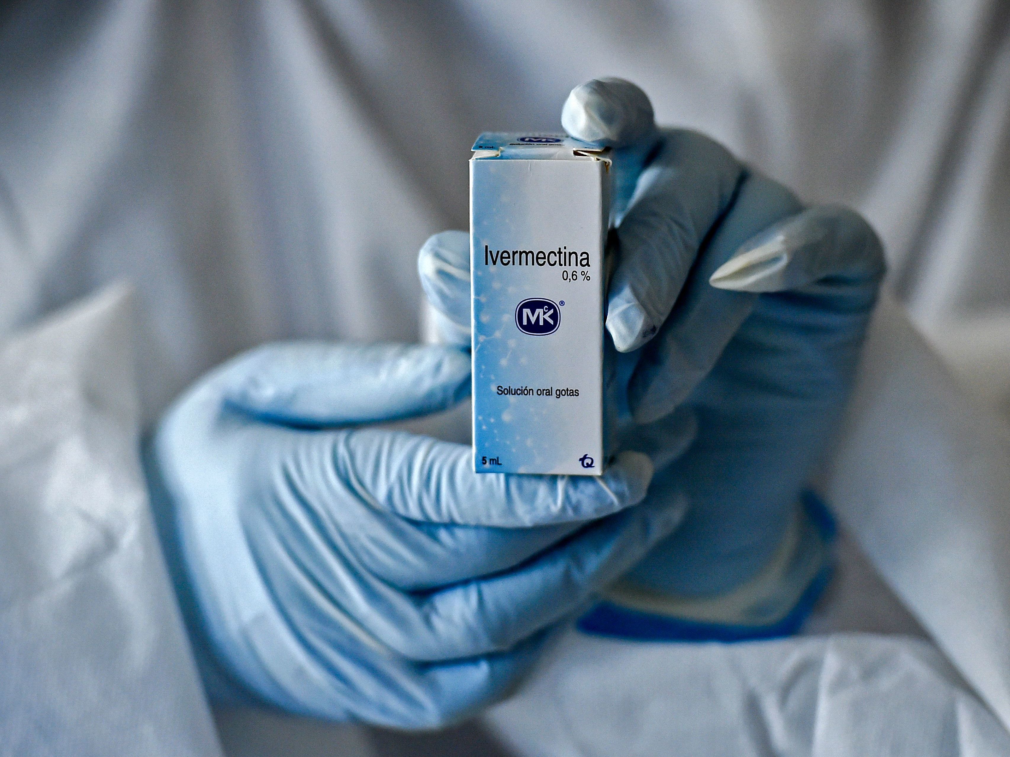 caption: A health worker shows a box containing a bottle of Ivermectin in Cali, Colombia, on July 21, 2020.