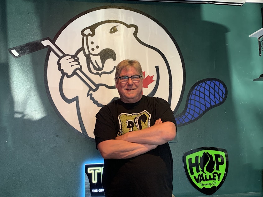 caption: Tim Pipes, owner of The Angry Beaver in Greenwood, poses in front of the bar's mascot. The Beaver is Seattle's only hockey bar — Pipes founded it when he couldn't find a spot to watch his beloved Toronto Maple Leafs.