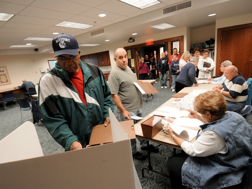 caption: Commissioners in Sandusky, Ohio, have voted to make Election Day a city holiday, in place of Columbus Day. Sandusky resident Moses Croom is seen here voting at a polling station at a local library in November 2008.
