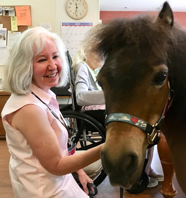 caption: Heidi Weston with her miniature therapy horse, Trusty. 