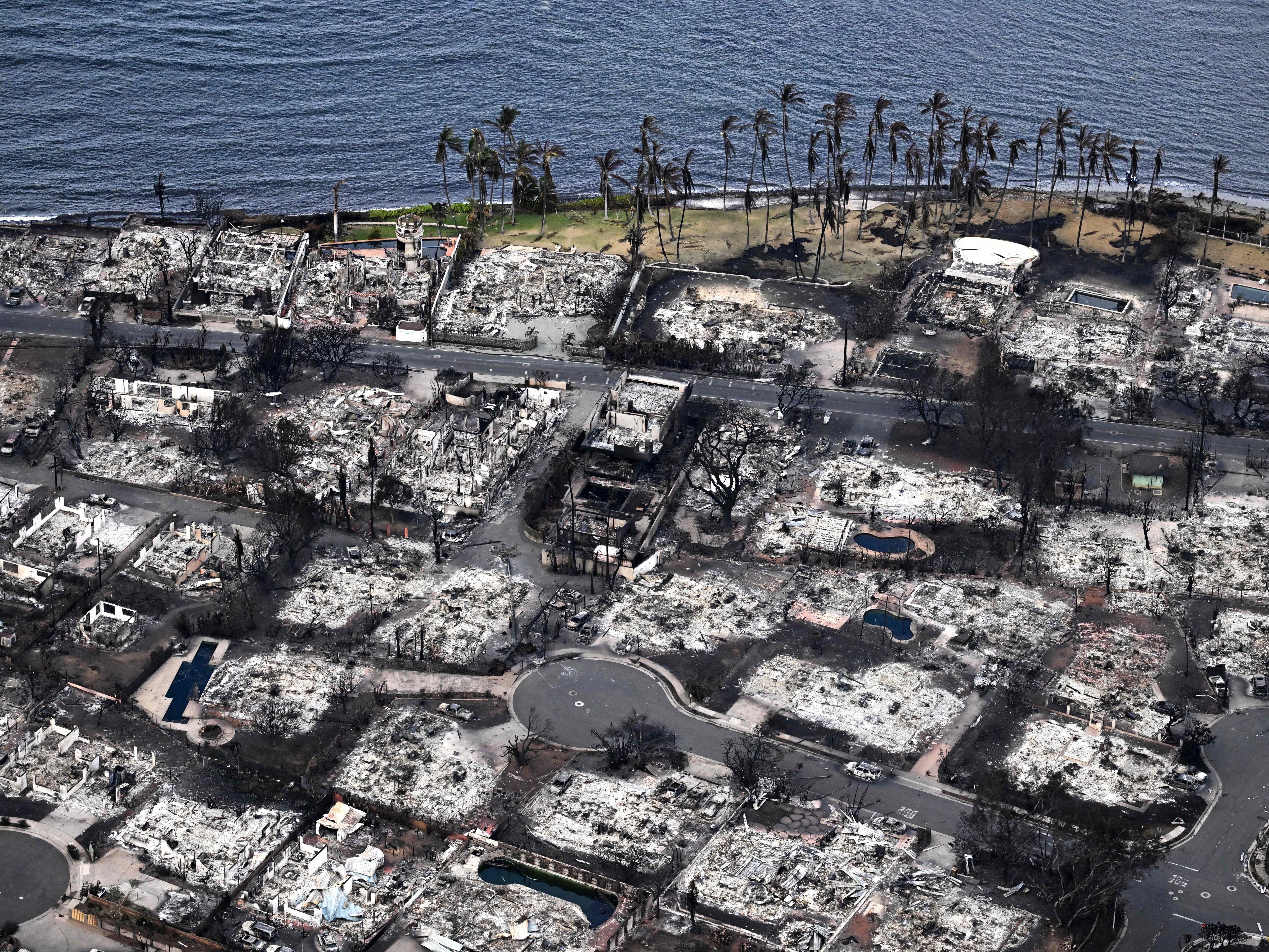 caption: An aerial image taken on Aug. 10, 2023 shows destroyed homes and buildings burned to the ground in Lahaina in the aftermath of wildfires in western Maui, Hawaii. Rumors and conspiracy theories quickly flourished after the fire, hampering relief efforts.