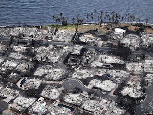 caption: An aerial image taken on Aug. 10, 2023 shows destroyed homes and buildings burned to the ground in Lahaina in the aftermath of wildfires in western Maui, Hawaii. Rumors and conspiracy theories quickly flourished after the fire, hampering relief efforts.