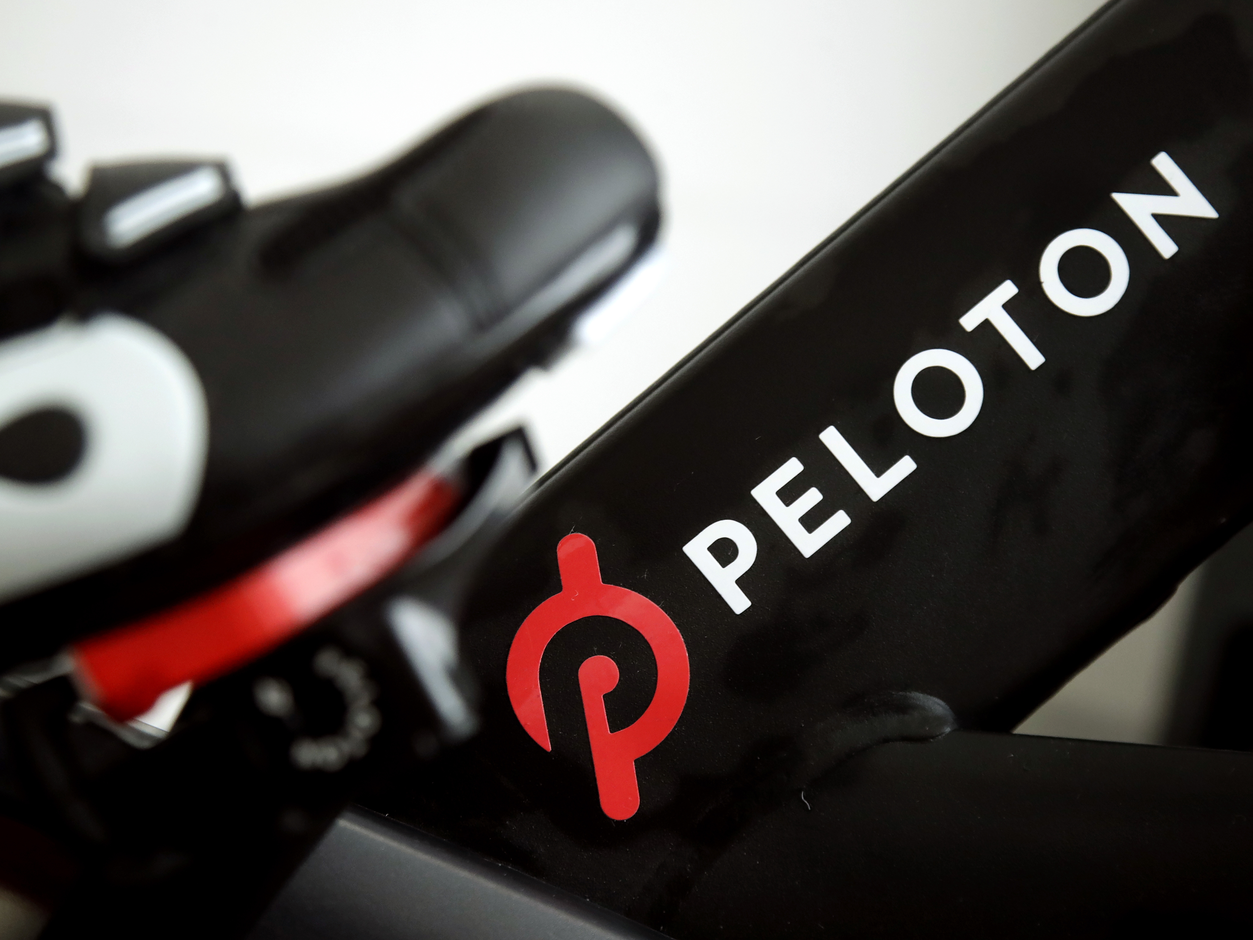 caption: This 2019 file photo shows the logo on a Peloton bike in San Francisco. The company is recalling 2.2 million of its popular bikes due to an issue with the machine's seat post.
