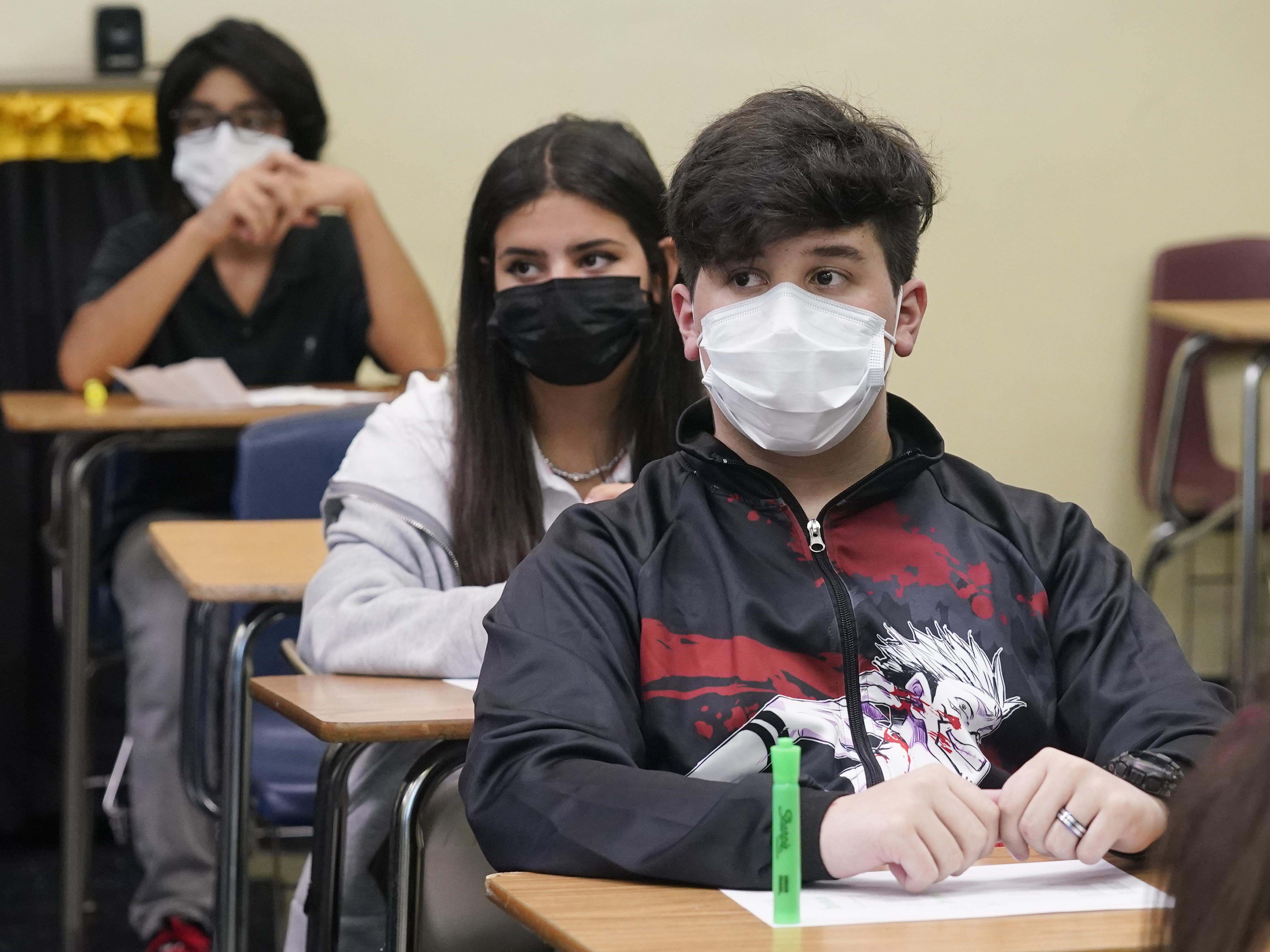 caption: Students sit in an algebra class at Barbara Coleman Senior High School on the first day of school on Monday in Miami Lakes, Fla. Miami-Dade County public schools require students to wear a mask to prevent the spread of COVID-19.