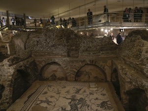 caption: Visitors explore the Roman Necropolis at The Vatican.