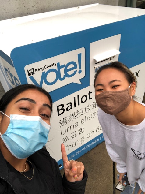 caption: Cymran Giri, left, votes with her friend for the first time this fall. Voting has been in the back of her mind, she says, since the last presidential election.