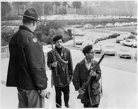 caption: Seattle Black Panthers gather on the steps of the Capitol in Olympia on February 28, 1969, to protest a bill aiming to make it a crime to exhibit firearms with 'an intent to intimidate others.'