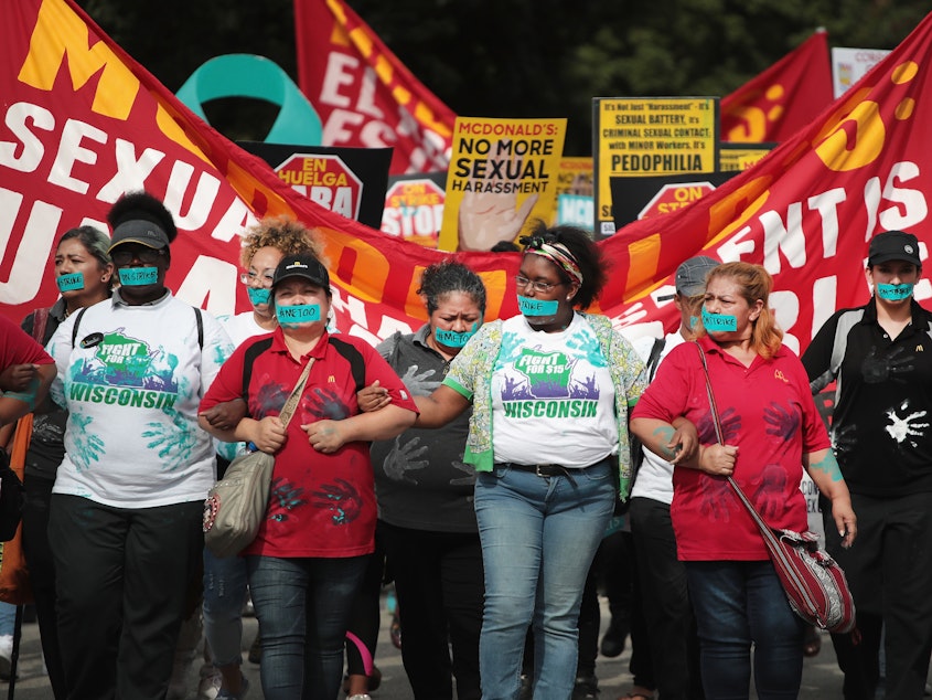 caption: McDonald's workers are joined by other activists as they march toward the company's Chicago headquarters to protest sexual harassment at the fast-food chain's restaurants on Sept. 18.