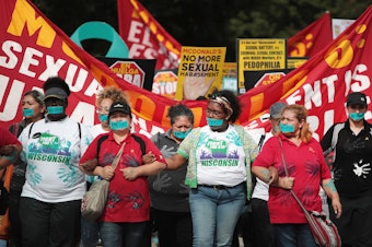 caption: McDonald's workers are joined by other activists as they march toward the company's Chicago headquarters to protest sexual harassment at the fast-food chain's restaurants on Sept. 18.