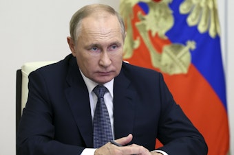 caption: Russian President Vladimir Putin speaks to a regional governor via videoconference at the Novo-Ogaryovo residence outside Moscow, Russia, on Oct. 21, 2022. The International Criminal Court said Friday it has issued an arrest warrant for Putin and his children's rights commissioner for possible war crimes.