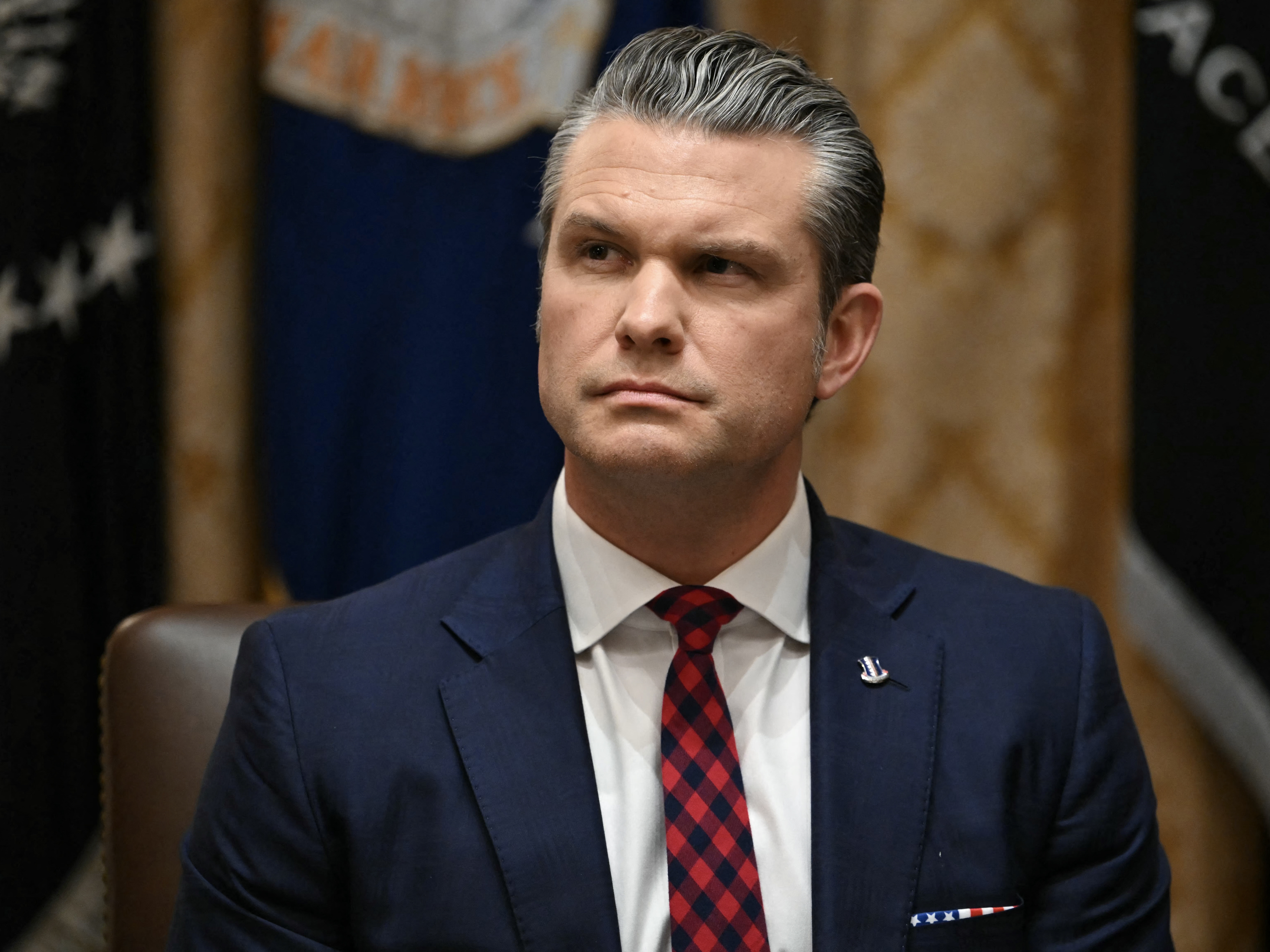 caption: Secretary of Defense Pete Hegseth listens as President Donald Trump speaks during a Cabinet Meeting at the White House on Dec. 2.