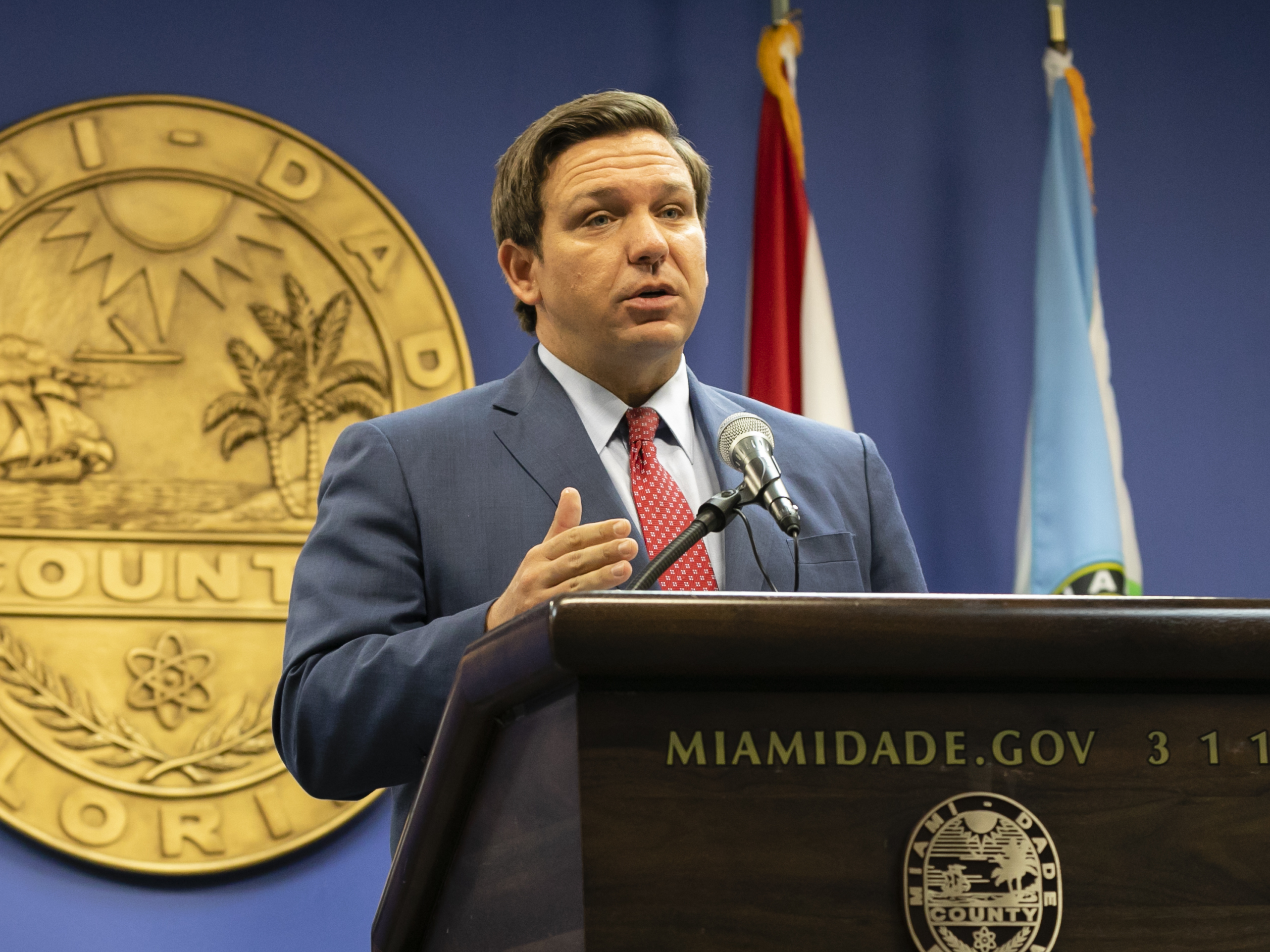 caption: Florida Gov. Ron DeSantis, here in June, said this week that the state's troubled unemployment portal was designed to discourage people applying for benefits. The portal launched in 2013 under then-Gov. Rick Scott, now a U.S. senator.