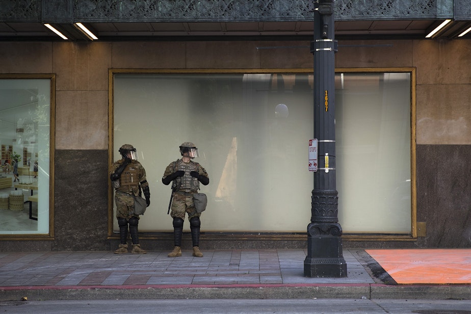 caption: In this file photo, Washington National Guard members are stationed near Westlake Park on June 1, 2020, in Seattle.