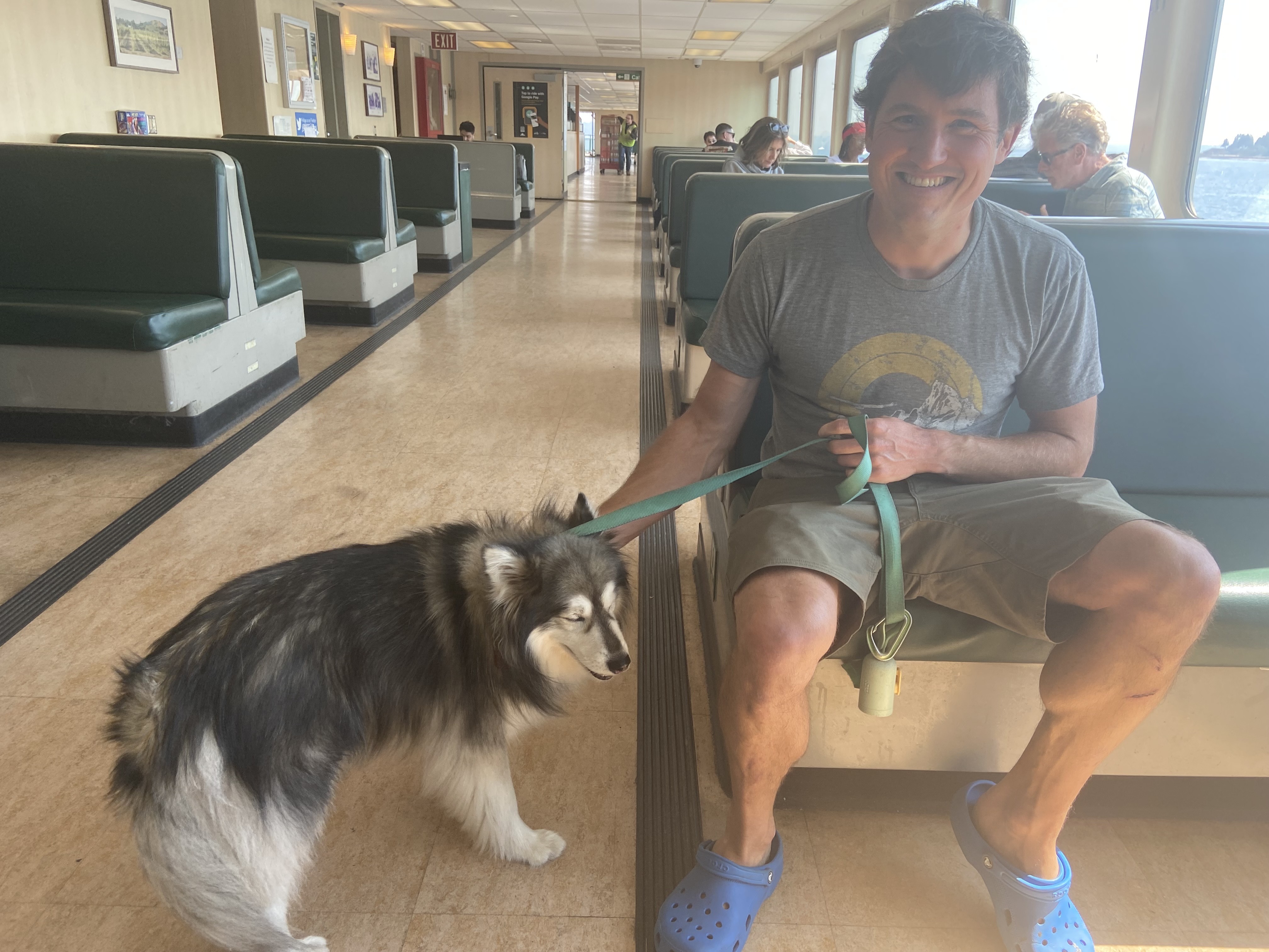 caption: Nicholas Sedney sits inside the Walla Walla's passenger cabin with his dog, Earl.