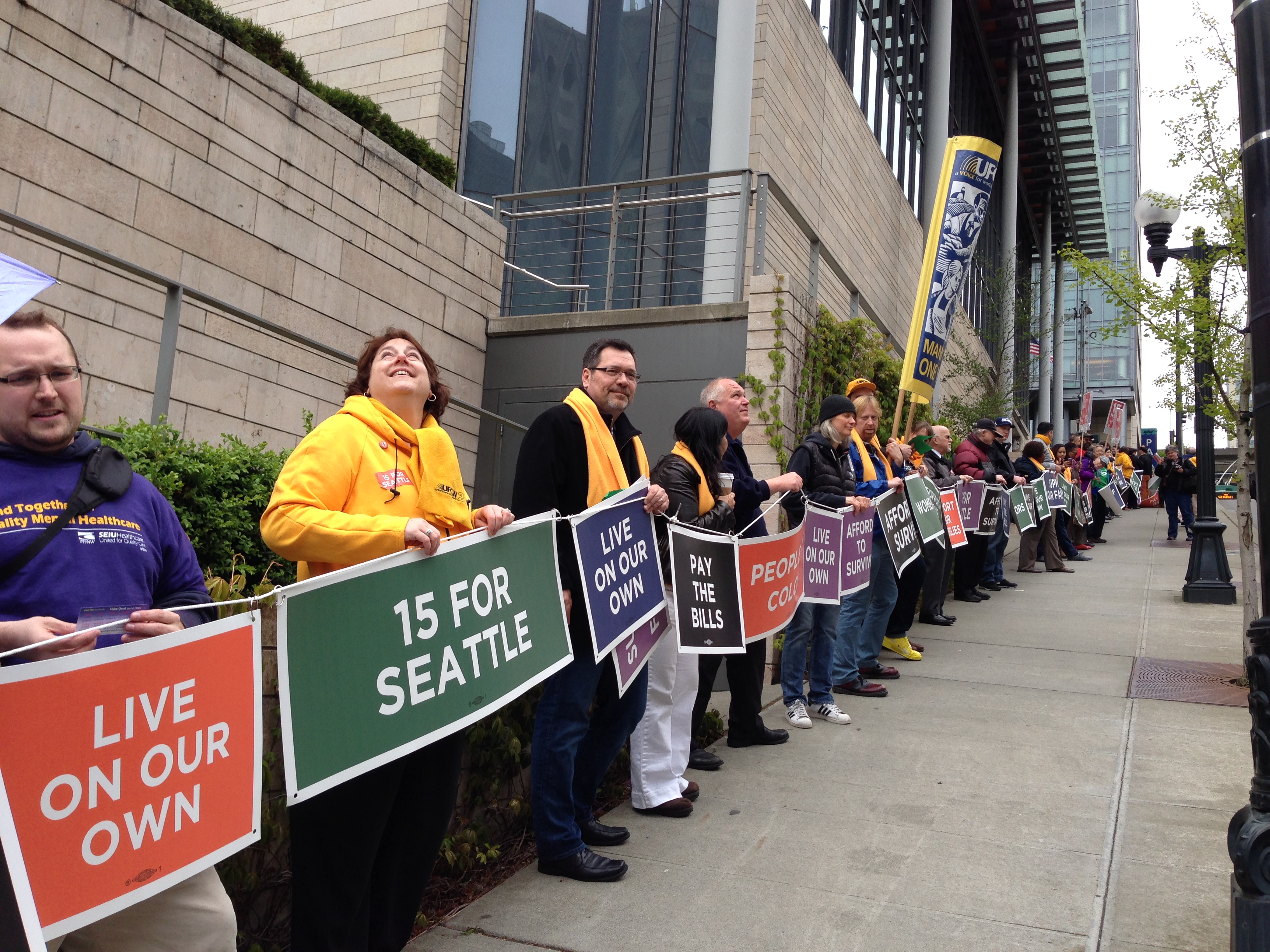 caption: Demonstrators in Seattle formed a human chain around City Hall Wednesday in support of a $15 minimum wage.