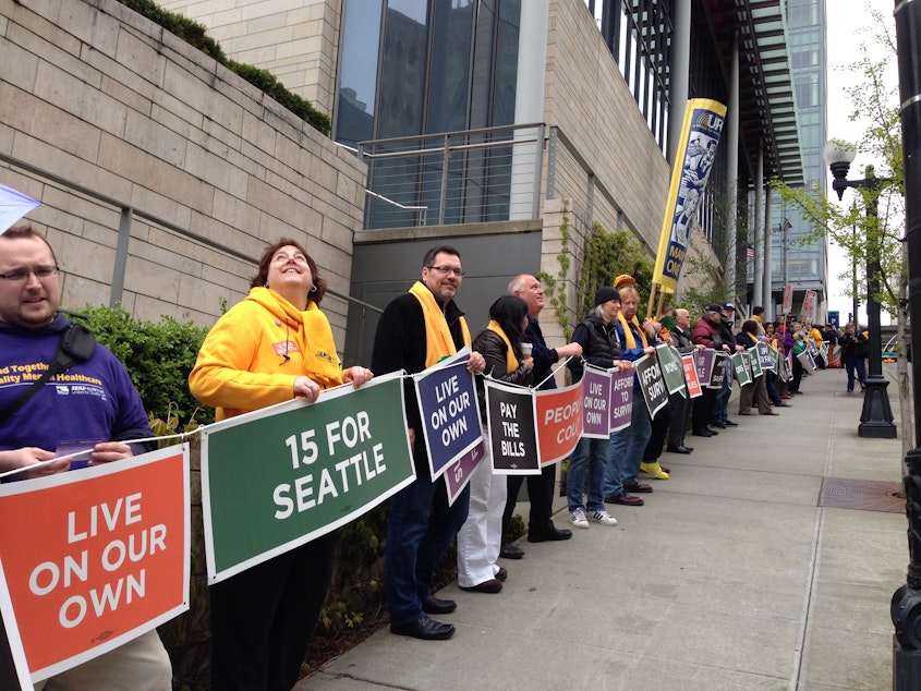 caption: Demonstrators in Seattle formed a human chain around City Hall Wednesday in support of a $15 minimum wage.