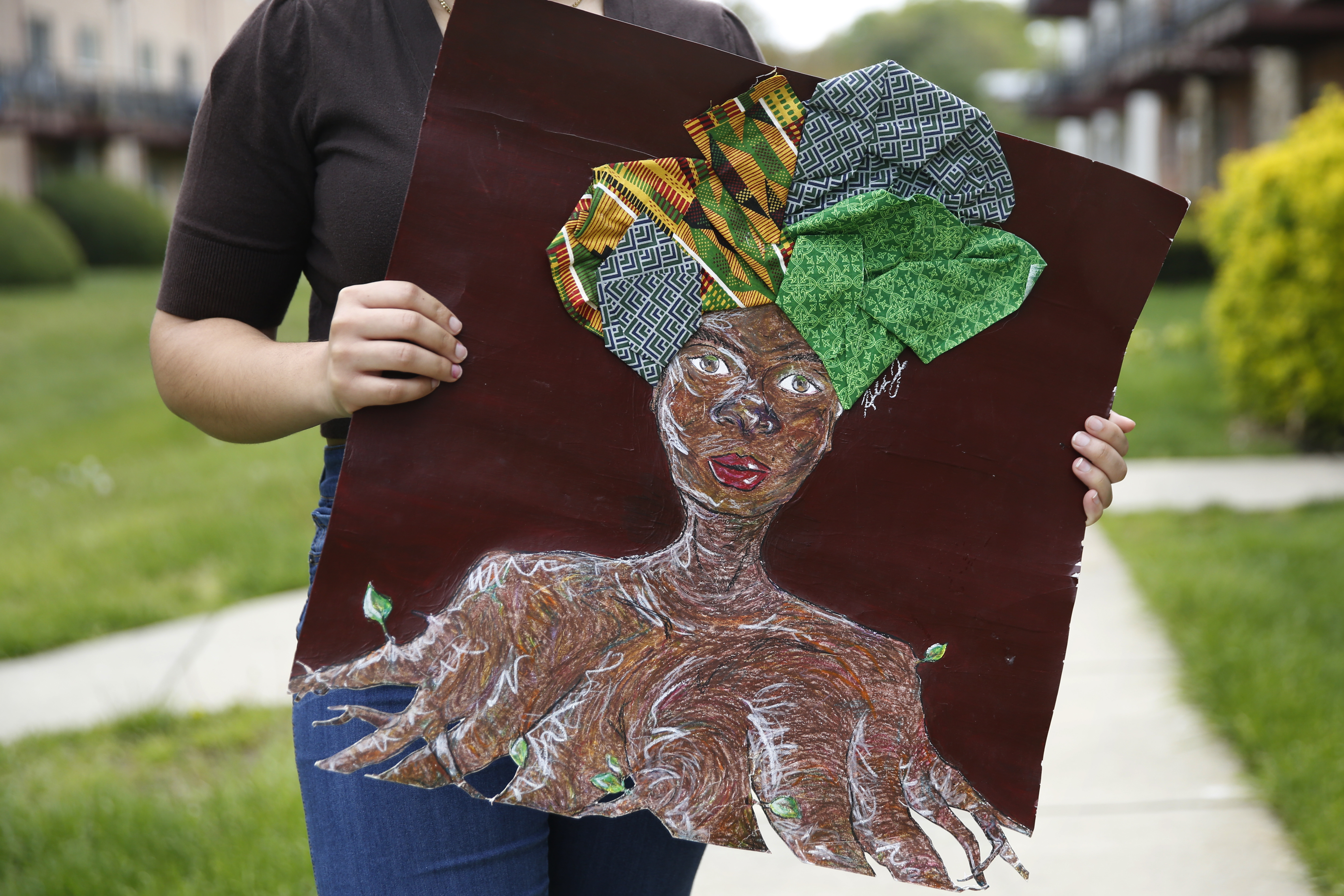 caption: The things that bring Jones, a high school senior, joy in isolation? Painting with acrylics and daydreaming about college.