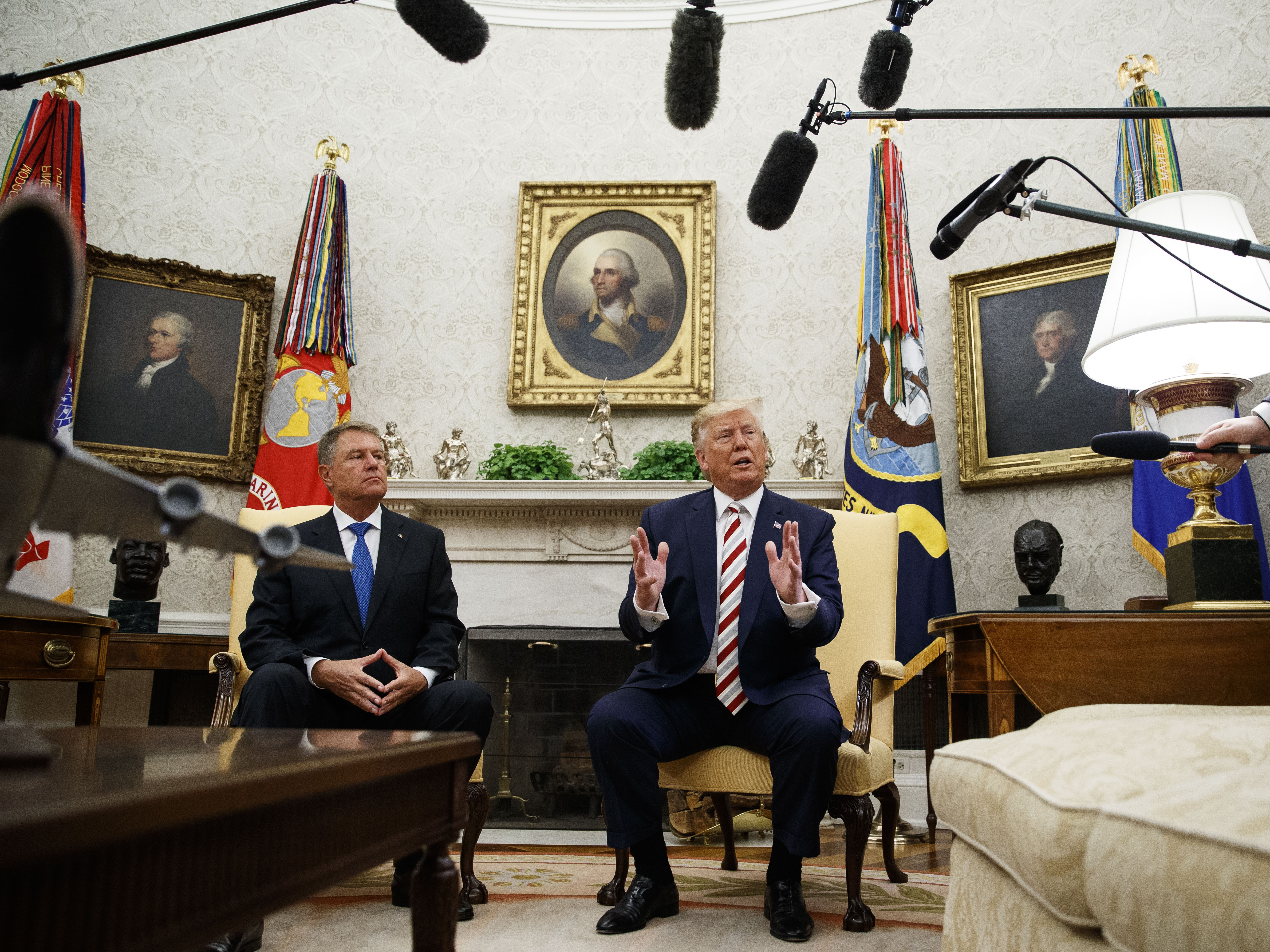 caption: President Trump spoke during a meeting with Romanian President Klaus Iohannis in the Oval Office. He has softened his position on background checks since earlier this month.