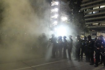 caption: Police officers fire rubber bullets May 29 during a Los Angeles protest over the death of George Floyd.